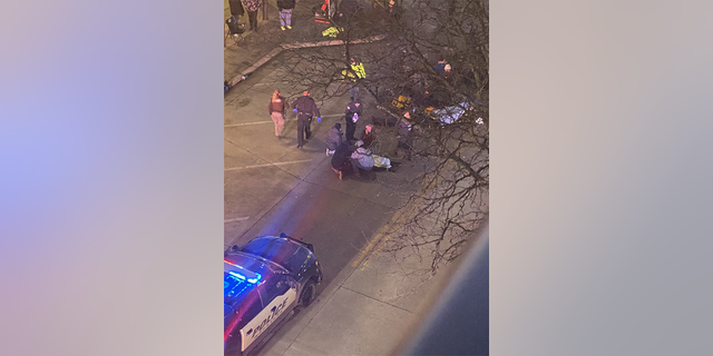 Police officers clearing the street.