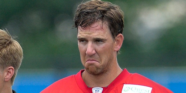 New York Giants quarterback Eli Manning (10) with a scowl on his face.New York Giants Training Camp @ Quest Diagnostics Training Center. Tuesday, July 22, 2014  in East Rutherford.