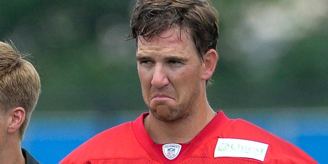 New York Giants quarterback Eli Manning (10) with a scowl on his face.New York Giants Training Camp @ Quest Diagnostics Training Center. Tuesday, July 22, 2014 in East Rutherford.