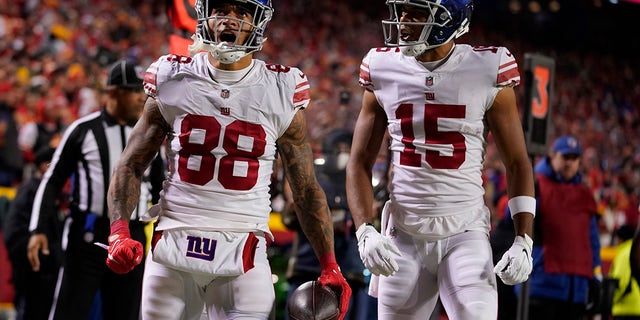 New York Giants' Evan Engram (88) is congratulated by Collin Johnson (15) after scoring during the second half of an NFL football game Monday, Nov. 1, 2021, in Kansas City, Mo.