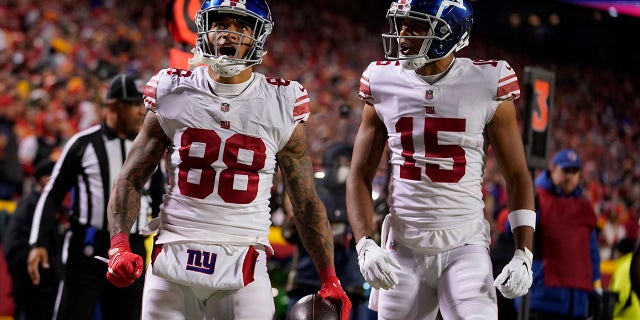 New York Giants' Evan Engram (88) is congratulated by Collin Johnson (15) after scoring during the second half of an NFL football game Monday, Nov. 1, 2021, in Kansas City, Mo.