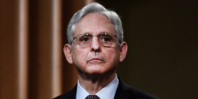 Attorney General Merrick Garland listens during a news conference over ransomware cyber-attack at the Department of Justice in Washington on November 8, 2021.