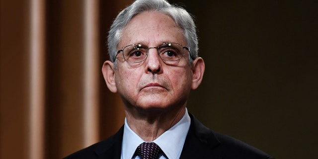 Attorney General Merrick Garland listens during a news conference over ransomware cyber-attack at the Department of Justice in Washington on November 8, 2021.