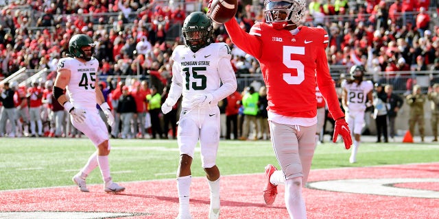 COLUMBUS, OHIO - NOVEMBER 20: Garrett Wilson #5 of the Ohio State Buckeyes celebrates his touchdown during the first half of a game against the Michigan State Spartans at Ohio Stadium on November 20, 2021 in Columbus, Ohio.