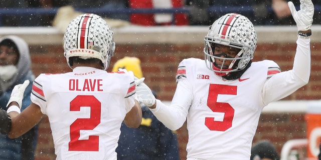 ANN ARBOR, MICHIGAN - NOVEMBER 27: Garrett Wilson #5 of the Ohio State Buckeyes celebrates his touchdown against the Michigan Wolverines with teammate Chris Olave #2 during the second quarter at Michigan Stadium on November 27, 2021 in Ann Arbor, Michigan.