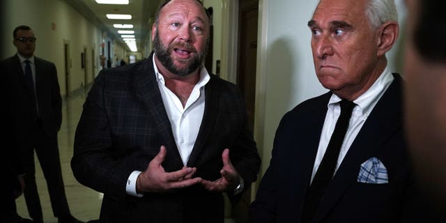 Longtime informal adviser to President Trump Roger Stone (R) and Alex Jones (L) of Infowars speak to cameras outside a hearing where Google CEO Sundar Pichai testified before the House Judiciary Committee at the Rayburn House Office Building on December 11, 2018 in Washington, DC. (Photo by Alex Wong/Getty Images)