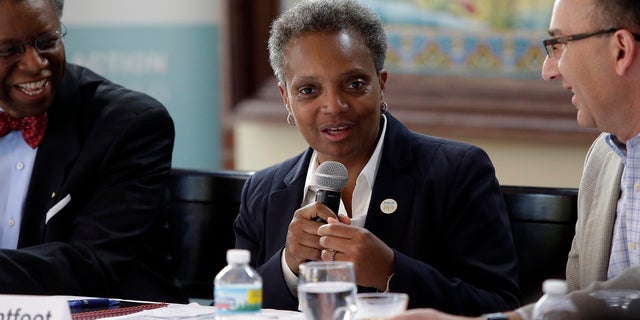 Reverend Randall Blakey (大号) and Thomas Applegate ([R), Executive Director of North River Commission listen as Chicago Mayor-Elect Lori Lightfoot speaks to residents and local-officials in the Albany Park neighborhood on Wednesday May 15, 2019 在芝加哥, 伊利诺伊州.