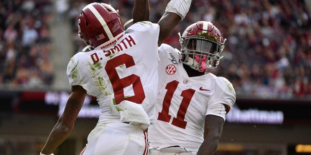 Henry Ruggs III and DeVonta Smith celebrate