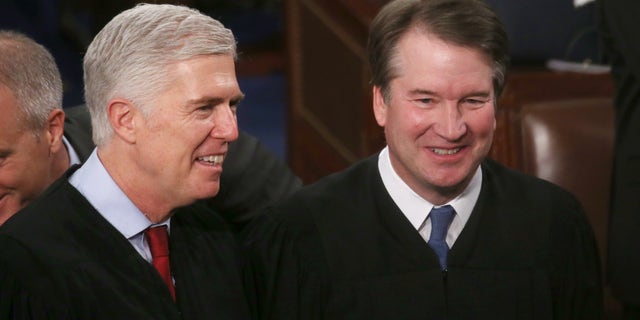 Supreme Court Justice Neil Gorsuch and Supreme Justice Brett Kavanaugh attend the State of the Union address in the chamber of the U.S. House of Representatives on Feb. 4, 2020 in Washington, D.C. (Photo by Mario Tama/Getty Images)