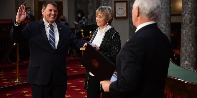 Senator Mike Rounds, RS.D., participates in a false oath to the 117th Congress with Vice President Mike Pence as his wife Jean Rounds holds a Bible, in the old Senate chamber of the US Capitol in Washington, DC on January 3, 2021. (Photo by KEVIN DIETSCH / AFP via Getty Images)