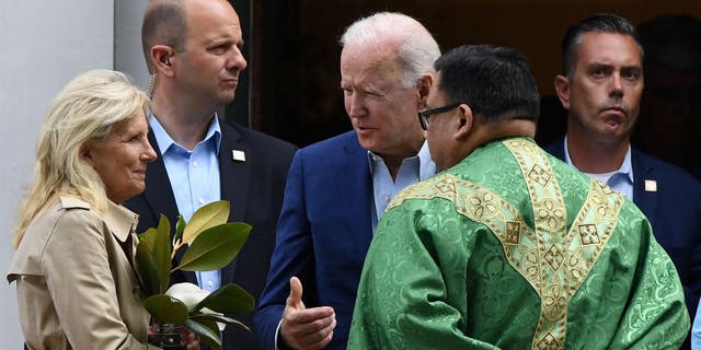 US President Joe Biden (C) and First Lady Jill Biden (L) speaks with a priest as they leave St. Joseph on the Brandywine Catholic Church in Wilmington, Delaware, June 19, 2021.