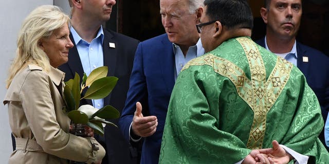 US President Joe Biden (C) and First Lady Jill Biden (L) speaks with a priest as they leave St. Joseph on the Brandywine Catholic Church in Wilmington, Delaware, June 19, 2021.