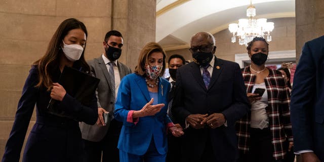 WASHINGTON, DC - SEPTEMBER 30: Speaker of the House Nancy Pelosi (D-CA) returns to her office, while she talks with Rep. James Clyburn after a bill enrollment ceremony for H.R. 5305, the Extending Government Funding and Delivering Emergency Assistance Act, on Thursday, Sept. 30, 2021 in Washington, DC.  (Kent Nishimura / Los Angeles Times via Getty Images)