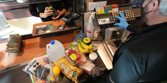 A cashier assists a customer at a checkout counter at Harmons Grocery store in Salt Lake City, Utah, U.S., on Thursday, Oct. 21, 2021. More than a year and a half after the coronavirus pandemic upended daily life, the supply of basic goods at U.S. grocery stores and restaurants is once again falling victim to intermittent shortages and delays. Photographer: George Frey/Bloomberg