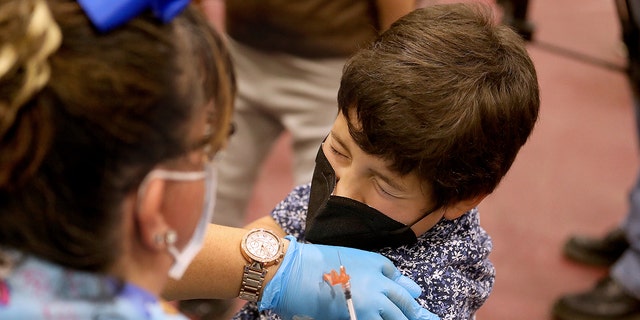 Luxiano (cq) Gonzalez, 8, of El Monte, receives a childs dose of the Pfizer vaccination from LVN Jacqueline Valdez at Eugene A. Obregon Park on Wednesday, Nov. 3, 2021 in Los Angeles, CA. (Gary Coronado / Los Angeles Times via Getty Images)