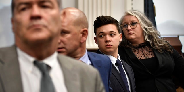 Kyle Rittenhouse, third from left, stands with his legal team, from left, Mark Richards, Corey Chirafisi and Natalie Wisco as the jury leaves the room for the day at the Kenosha County Courthouse on November 5, 2021 in Kenosha, Wisconsin. (Photo by Sean Krajacic - Pool/Getty Images)