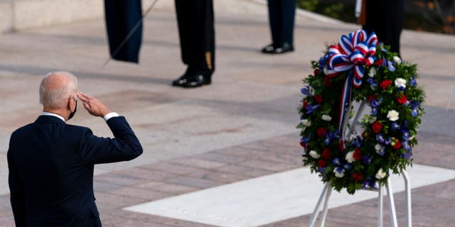US President Joe Biden salutes before placing a wreath during a centennial ceremony at the Tomb of the Unknown Soldier in Arlington National Cemetery on Nov. 11, 2021, in Arlington, Virginia.  