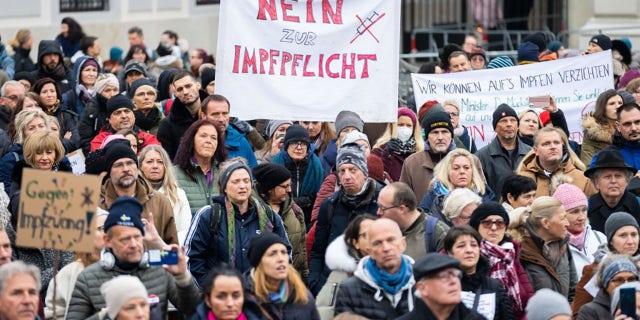 A demonstrator holds a placard reading 'No to compulsory vaccination' during an anti-vaccination protest at the Ballhausplatz in Vienna, Austria, on November 14, 2021. (Photo by GEORG HOCHMUTH/APA/AFP via Getty Images)