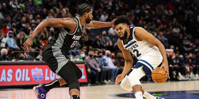 Karl-Anthony Dorpe #32 of the Minnesota Timberwolves dribbles the ball while Tristan Thompson #13 of the Sacramento Kings defends in the fourth quarter of the game at Target Center on November 17, 2021 in Minneapolis, Minnesota. The Timberwolves defeated the Kings 107-97. 