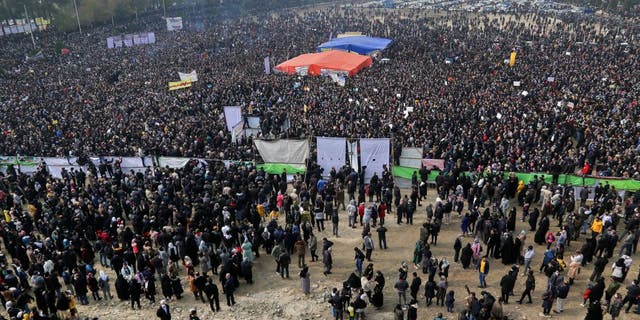 Iranians gather during a protest to voice their anger after their province's lifeblood river dried up due to drought and diversion, in the central city of Isfahan, on November 19, 2021. - The massive protest, that drew in farmers and other people from across Isfahan province, was the biggest since demonstrations over the water crisis started on November 9. (Photo by Fatmeh Nasr / ISNA / AFP) (Photo by FATMEH NASR/ISNA/AFP via Getty Images)