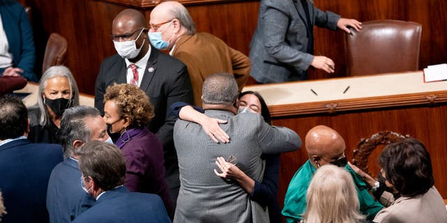 Rep. Alexandria Ocasio-Cortez embraces a fellow House Democrat after the vote Friday, Nov. 19, 2021, at the U.S. Capitol in Washington, D.C. (Stefani Reynolds/Bloomberg via Getty Images)