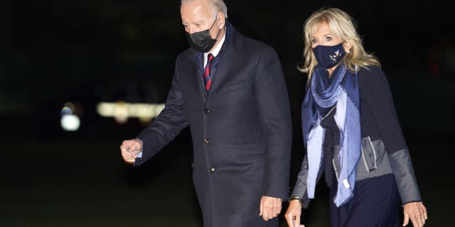 President Biden, left, and first lady Jill Biden walk on the South Lawn of the White House after arriving on Marine One in Washington, D.C., on Monday, Nov. 22, 2021. (Photographer: Yuri Gripas/Abaca/Bloomberg via Getty Images)