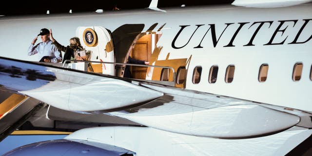 President Biden salutes and first lady Jill Biden waves as they board Air Force One at Joint Base Andrews, Maryland, on Tuesday, Nov. 23, 2021. (Photographer: Oliver Contreras/Bloomberg via Getty Images)