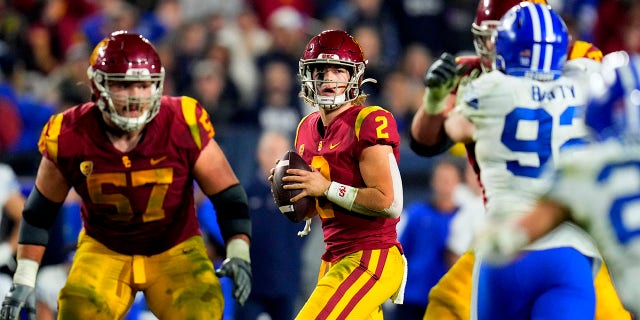 Los Angeles, CA - November 27:  Quarterback Jaxson Dart #2 of the USC Trojans passes against the Brigham Young Cougars in the second half of a NCAA football game at the Los Angeles Memorial Coliseum in Los Angeles on Saturday, November 27, 2021.