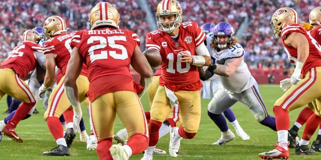 San Francisco 49ers quarterback Jimmy Garoppolo (#10) hands the ball off to running back Eli Mitchell on Nov. 28, 2021. The NFL franchise's name and gold helmets are a tribute to the California Gold Rush of 1849.