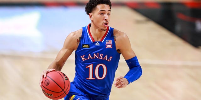 LUBBOCK, TEXAS - DECEMBER 17: Forward Jalen Wilson #10 of the Kansas Jayhawks handles the ball during the first half of the college basketball game against the Texas Tech Red Raiders at United Supermarkets Arena on December 17, 2020 in Lubbock, Texas. (Photo by John E. Moore III/Getty Images)