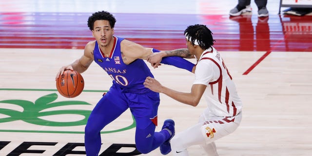 AMES, IA - FEBRUARY 13: Jalen Wilson #10 of the Kansas Jayhawks drives the ball as Jaden Walker #21 of the Iowa State Cyclones puts pressure on in the first half of play at Hilton Coliseum on February 13, 2021 in Ames, Iowa. The Kansas Jayhawks won 64-50 over the Iowa State Cyclones.(Photo by David Purdy/Getty Images)