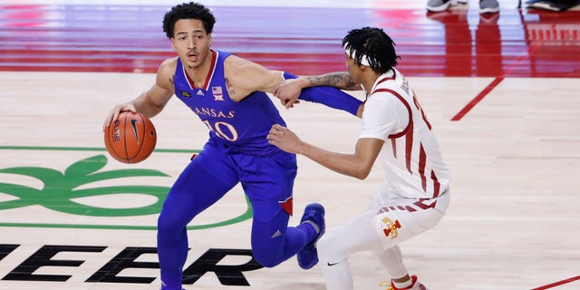 AMES, IA - FEBRUARY 13: Jalen Wilson #10 of the Kansas Jayhawks drives the ball as Jaden Walker #21 of the Iowa State Cyclones puts pressure on in the first half of play at Hilton Coliseum on February 13, 2021 in Ames, Iowa. The Kansas Jayhawks won 64-50 over the Iowa State Cyclones.(Photo by David Purdy/Getty Images)