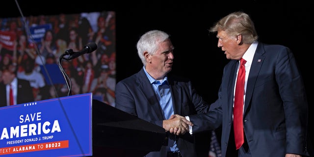 Former President Trump welcomes candidate for Senate and Rep. Mo Brooks to the stage during a rally at York Family Farms on Aug. 21, 2021, in Cullman, Alabama.