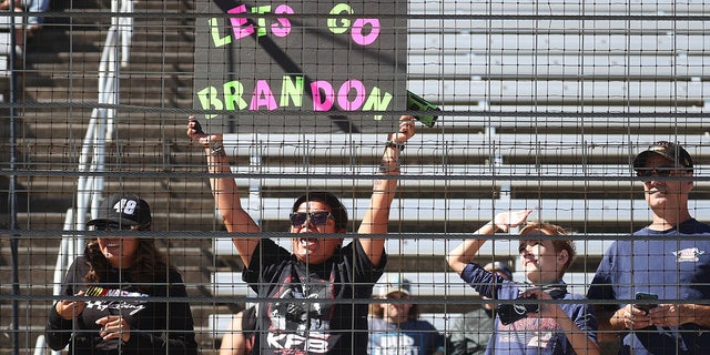 A NASCAR fan holds a "Lets Go Brandon" sign during the NASCAR Xfinity Series Andy's Frozen Custard 335 at Texas Motor Speedway on Oct. 16, 2021m in Fort Worth, Texas. (Photo by Chris Graythen/Getty Images)