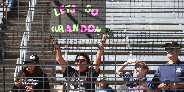 FORT WORTH, TEXAS - OCTOBER 16: A NASCAR fan holds a "Lets Go Brandon" sign during the NASCAR Xfinity Series Andy's Frozen Custard 335 at Texas Motor Speedway on October 16, 2021 in Fort Worth, Texas. (Photo by Chris Graythen/Getty Images)