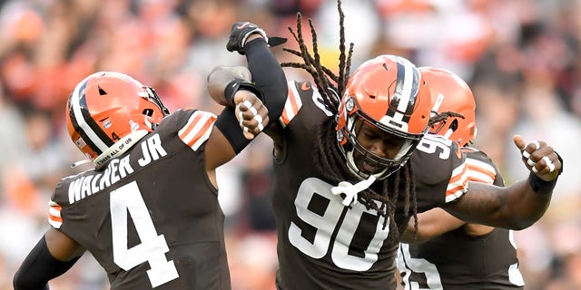 CLEVELAND, OHIO - OCTOBER 17: Jadeveon Clowney #90 and Anthony Walker #4 of the Cleveland Browns celebrate a sack by Clowney during the second quarter against the Arizona Cardinals at FirstEnergy Stadium on October 17, 2021, in Cleveland, Ohio. 