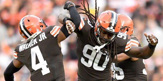 Jadeveon Clowney #90 and Anthony Walker #4 of the Cleveland Browns celebrate a sack by Clowney during the second quarter against the Arizona Cardinals at FirstEnergy Stadium on October 17, 2021 in Cleveland, Ohio. 