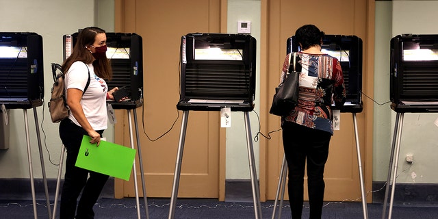 Voters cast their ballots at a polling station on Nov. 2, 2021, in Miami, Florida.