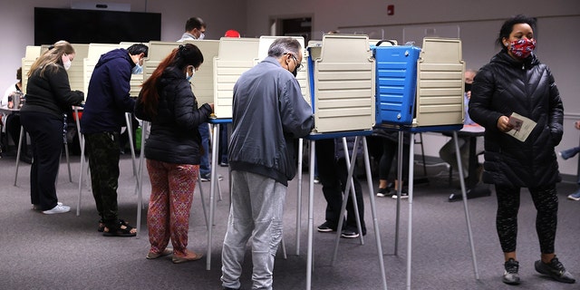 Voters cast ballots at the Fairfax County Government Center on November 2, 2021 in Fairfax, Virginia. 
