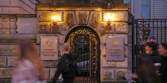 BERLIN, GERMANY - NOVEMBER 05: People walk past the Russian Embassy on November 05, 2021 in Berlin, Germany. A Russian diplomat of the embassy was reportedly found dead on the sidewalk in front of the embassy on October 19, apparently after having fallen from a window. Media are reporting that the man, 35, was an agent of the FSB, Russia's intelligence agency, and the son of a high-ranking FSB official.