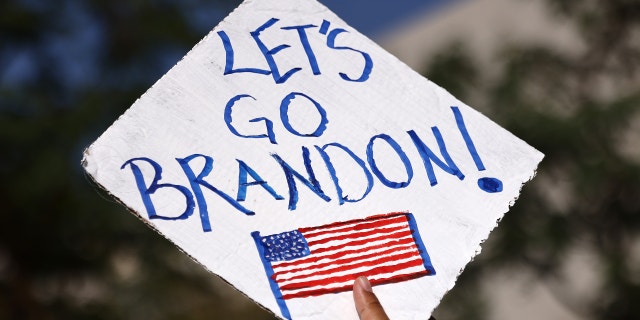 A protestor holds a 'Let's Go Brandon!' sign in Grand Park at a ‘March for Freedom’ rally demonstrating against the L.A. City Council’s COVID-19 vaccine mandate for city employees and contractors on November 8, 2021 in Los Angeles, California. The City Council has set a deadline of December 18 for all city employees and contractors to be vaccinated except for those who have religious or medical exemptions. (Photo by Mario Tama/Getty Images)