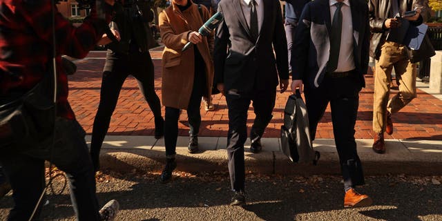 ALEXANDRIA, VA - NOVEMBER 10: Russian analyst Igor Danchenko is pursued by journalists as he departs the Albert V. Bryan U.S. Courthouse after being arraigned on November 10, 2021 in Alexandria, Virginia.  Danchenko has been charged with five counts of making false statements to the FBI regarding the sources of the information he gave the British firm that created the so-called "Steele Dossier," which alleged potential ties between the 2016 Trump campaign and Russia. (Photo by Chip Somodevilla/Getty Images)
