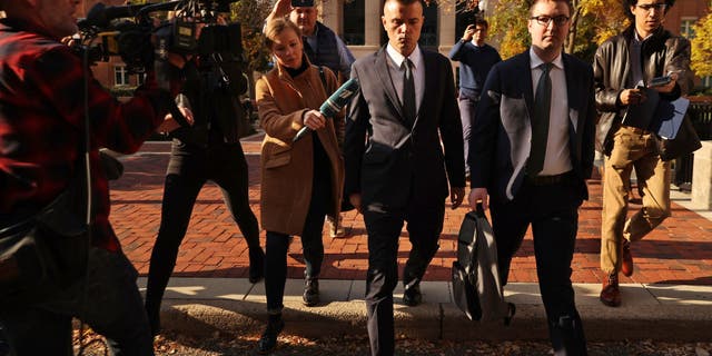 ALEXANDRIA, VA - NOVEMBER 10: Russian analyst Igor Danchenko is pursued by journalists as he departs the Albert V. Bryan US Courthouse after being arraigned on November 10, 2021 in Alexandria, Virginia.  Danchenko has been charged with five counts of making false statements to the FBI regarding the sources of the information he gave the British firm that created the so-called "Steele Dossier," which alleged potential ties between the 2016 Trump campaign and Russia.  (Photo by Chip Somodevilla/Getty Images)