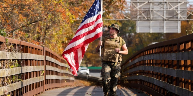 US Marine Corps. Veteran Al Pelosi, of East Islip, NY, is shown honoring veterans by walking some 3 miles with an American flag on the trail along Sunrise Highway near Connecticut River State Park Preserve in Oakdale, New York, last November. Veterans are applying to help fill teacher vacancies in Florida classrooms this year.