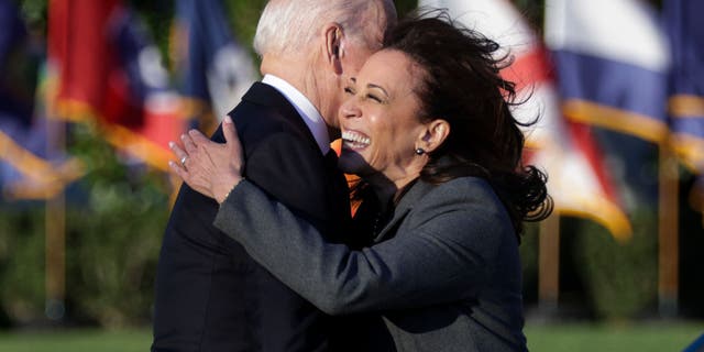 US Vice President Kamala Harris embraces President Joe Biden as she prepares to make a statement at the signing of the Infrastructure Investment and Employment Act on the South Lawn at the White House in Washington, DC on November 15, 2021. (Photo by Alex Wong / Getty Images)