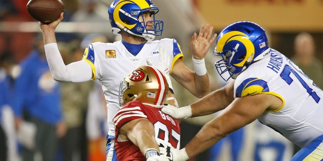 Matthew Stafford (9) of the Los Angeles Rams is pressured by Nick Bosa (97) of the San Francisco 49ers in the fourth quarter against the Los Angeles Rams at Levi's Stadium on Nov. 15, 2021, in Santa Clara, California.