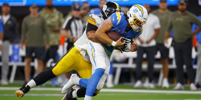 Cameron Heyward #97 of the Pittsburgh Steelers tackles Justin Herbert #10 of the Los Angeles Chargers during the fourth quarter at SoFi Stadium on November 21, 2021 in Inglewood, California.