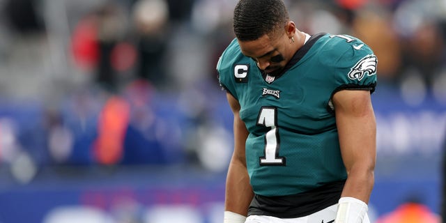 Jalen Hurts of the Philadelphia Eagles hangs his head as he walks off the field after his team's loss against the New York Giants at MetLife Stadium Nov. 28, 2021 in East Rutherford, N.J.
