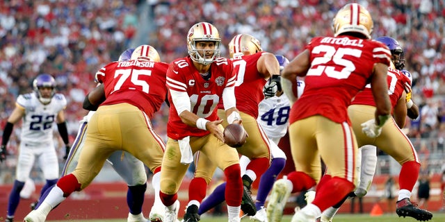 Jimmy Garoppolo #10 of the San Francisco 49ers looks to pitch the ball back to Elijah Mitchell #25 in the second half against the Minnesota Vikings at Levi's Stadium on Nov. 28, 2021 in Santa Clara, California. 