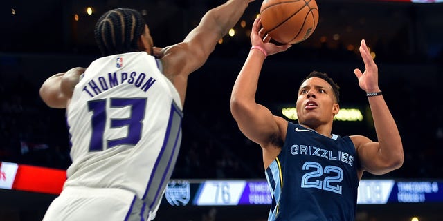 MEMPHIS, TENNESSEE - NOVEMBER 28: Desmond Bane #22 of the Memphis Grizzlies shoots against Tristan Thompson #13 of the Sacramento Kings during the second half at FedExForum on November 28, 2021 in Memphis, Tennessee. 